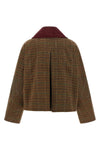 the ganni short jacket redefines the proportions of the outerwear through a boxy