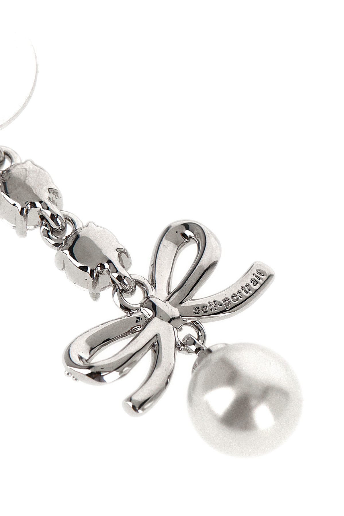 the self-portrait bow crystal charm pendant earrings feature a cascading metal