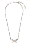 the self-portrait crystal pearl bow necklace defines the décolleté through a r