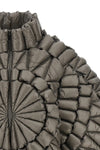 the raxxy down jacket redefines the volumes of outerwear through a complex three
