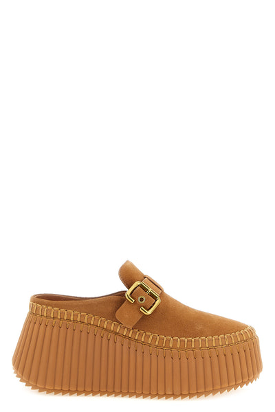 nama chloe sabots redefine the volumes of contemporary footwear through a slip-o