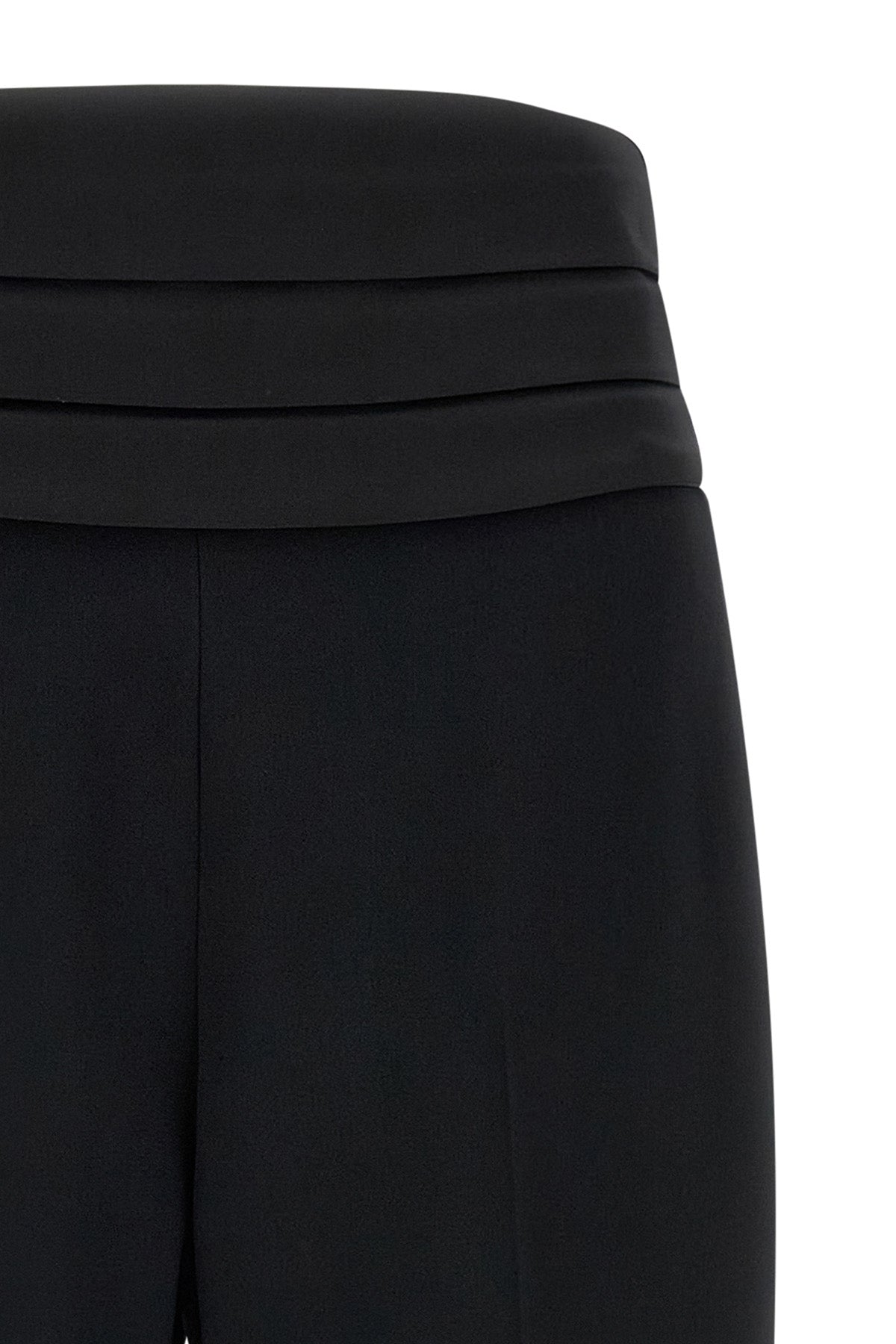 the tuxedo-inspired trousers by ermanno scervino define a slender silhouette thr