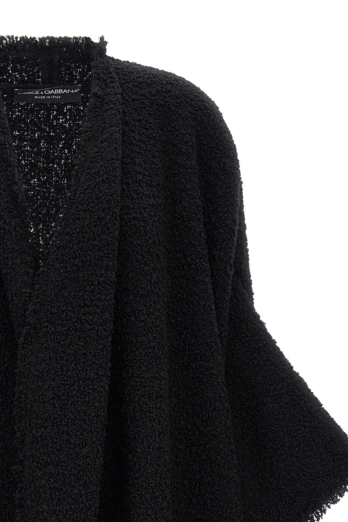 the dolce & gabbana bouclé cape stands out for its large volume