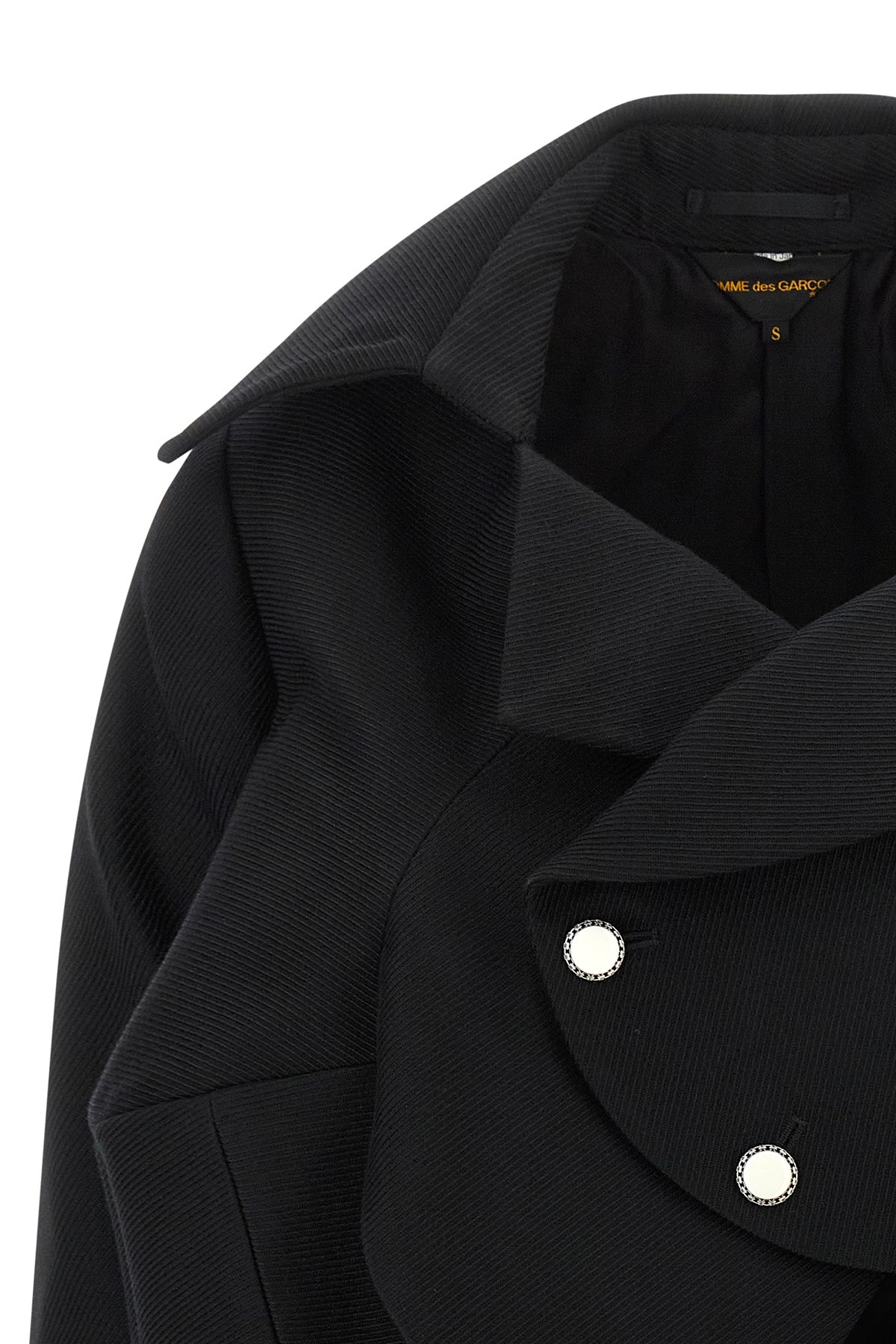 the comme des garçons blazer redefines traditional tailoring through an asymmetr