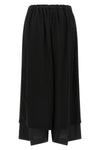 the comme des garcons trousers are distinguished by a fluid and voluminous silho