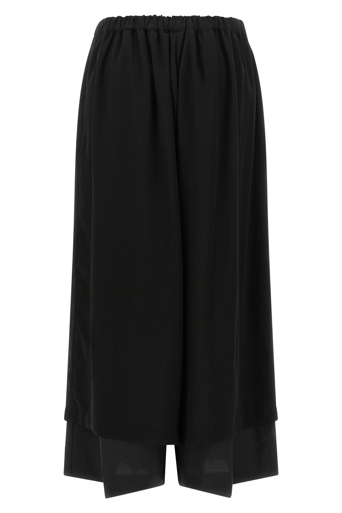 the comme des garcons trousers are distinguished by a fluid and voluminous silho