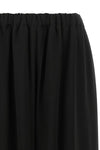 the comme des garcons trousers are distinguished by a fluid and voluminous silho