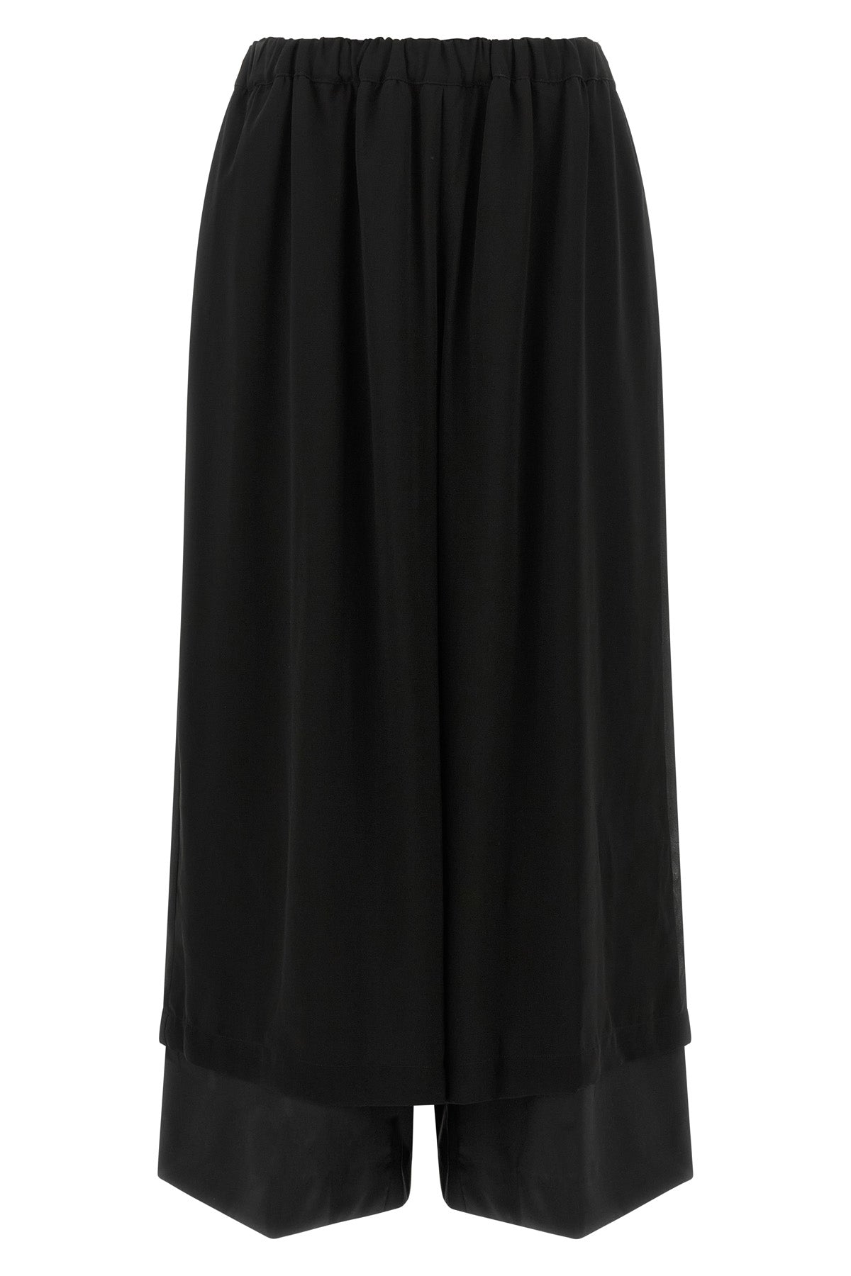 the comme des garcons trousers are distinguished by a fluid and voluminous silho
