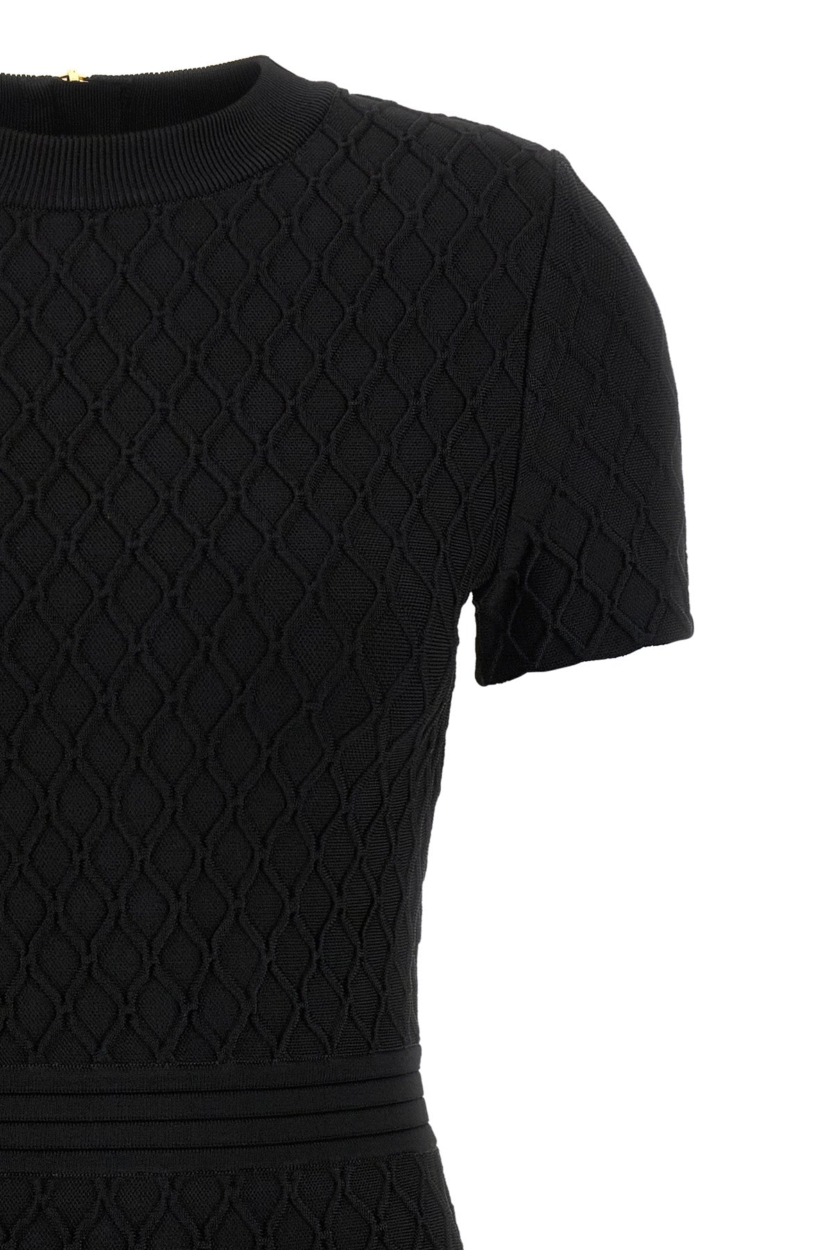 the flared balmain skater dress redefines knitwear codes through an hourglass