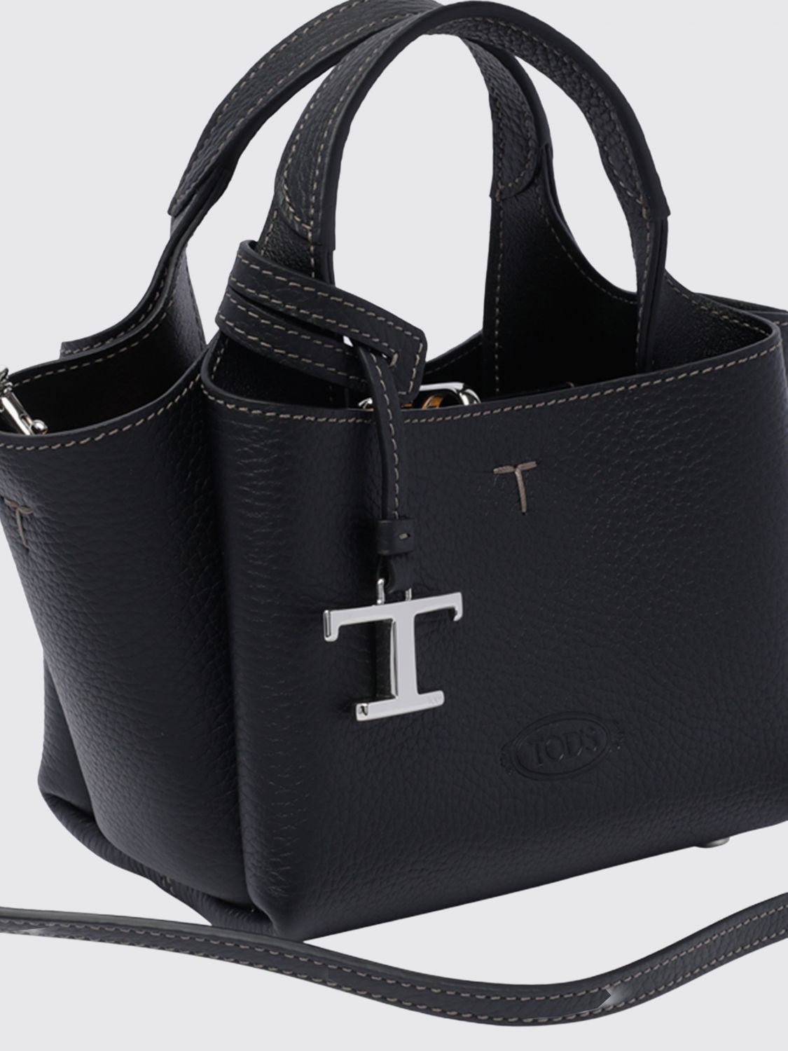 small grained leather handbag with flared design and charm