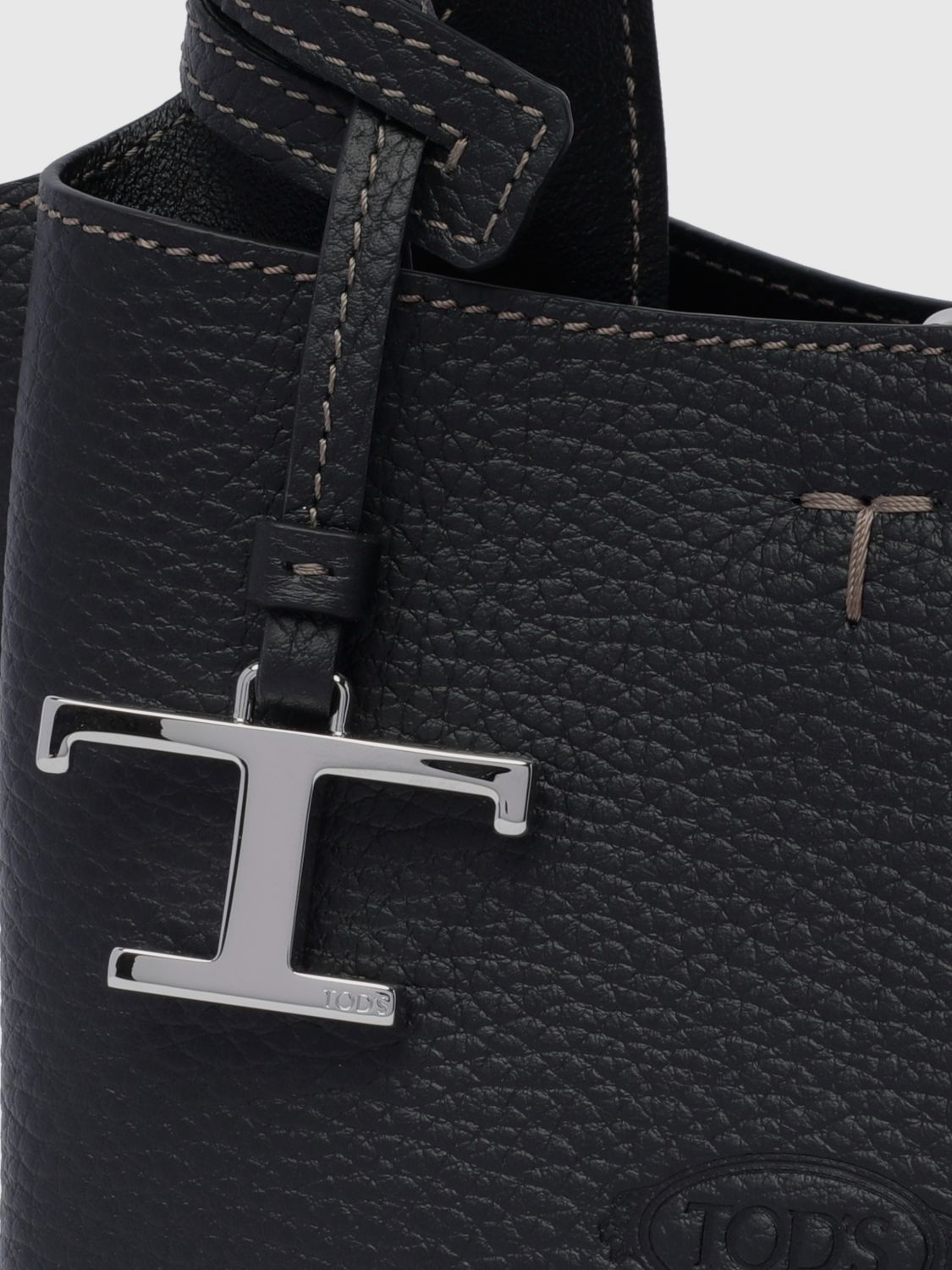 small grained leather handbag with flared design and charm