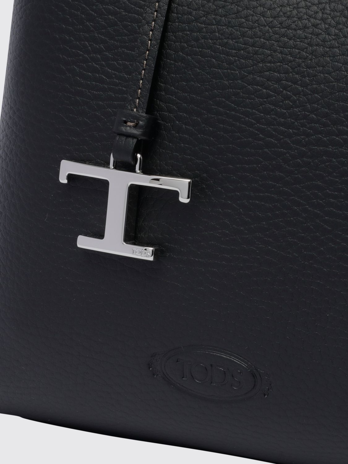 grained leather mini handbag with charm and embossed logo