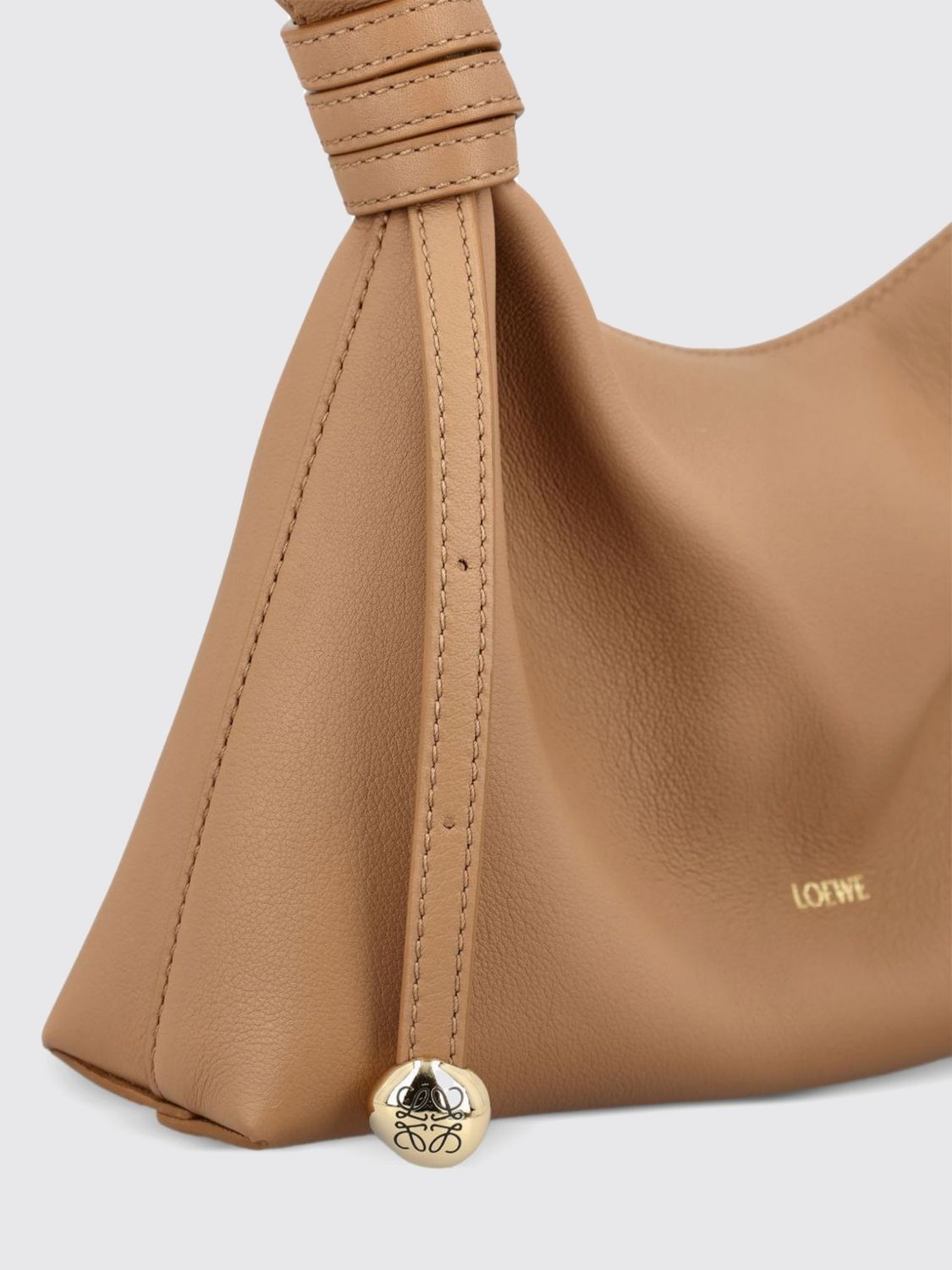 suede shoulder bag with decorative knot and metallic ring