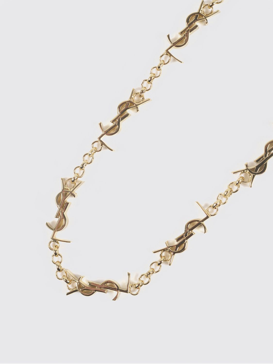 gold-tone metal bracelet with interlaced ysl monogram pendant