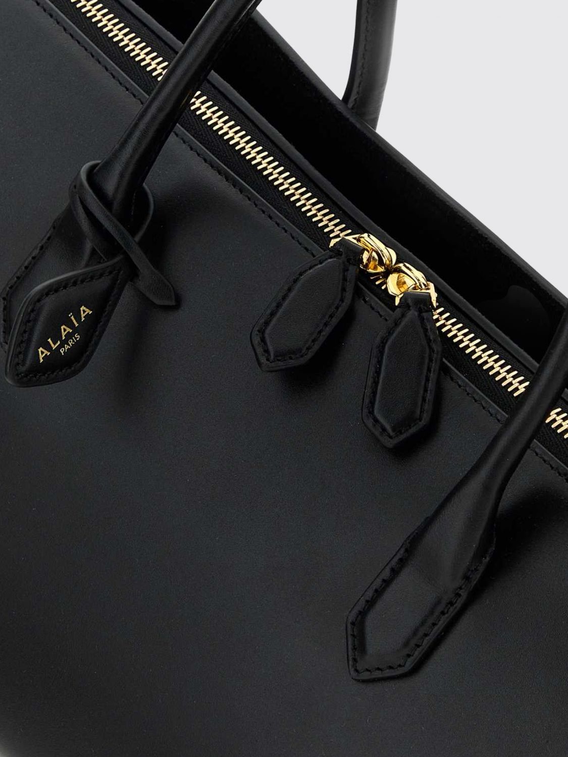 delta medium calfskin leather handbag with logo charm