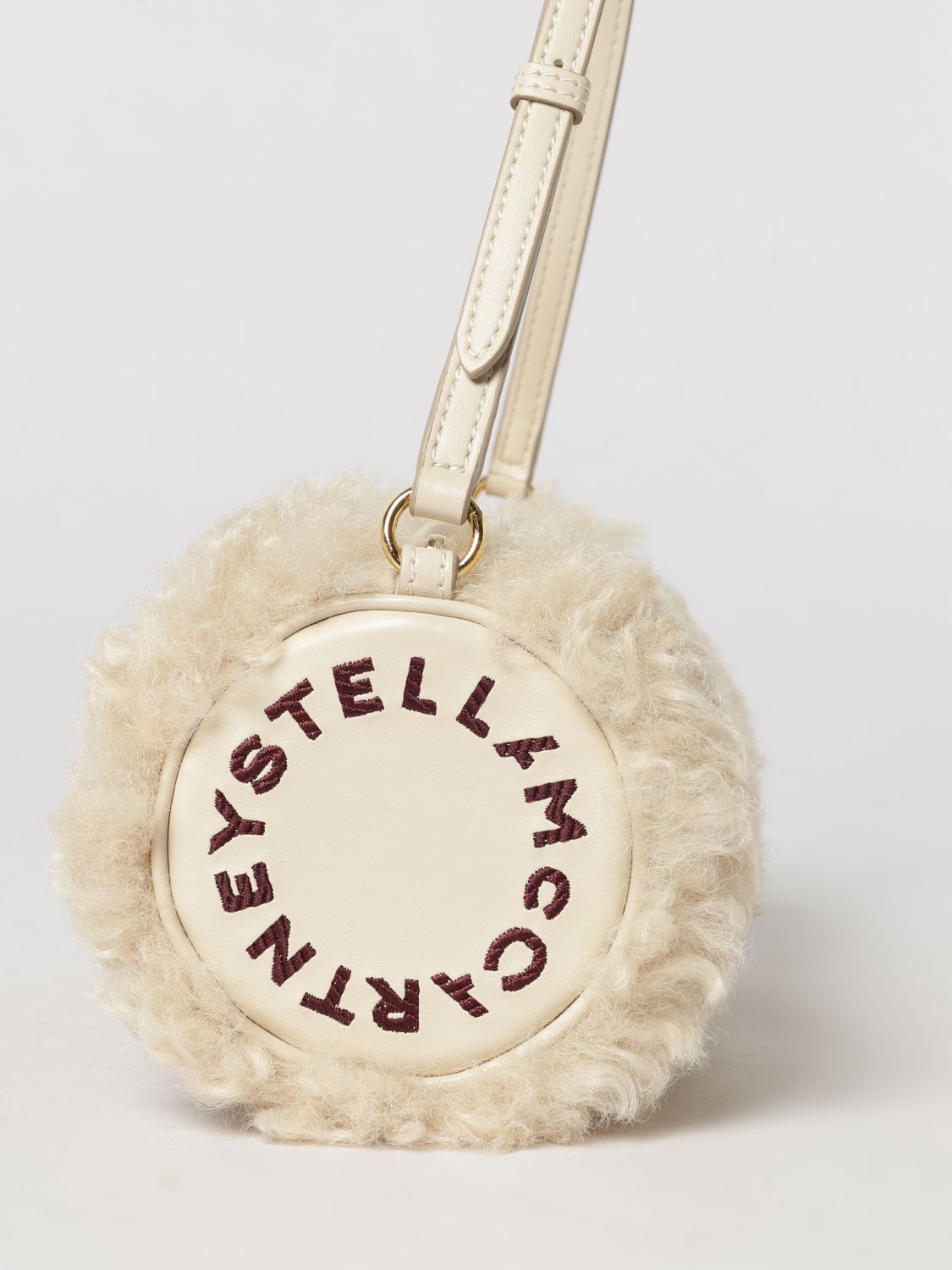 cylindrical shearling shoulder bag with adjustable handle