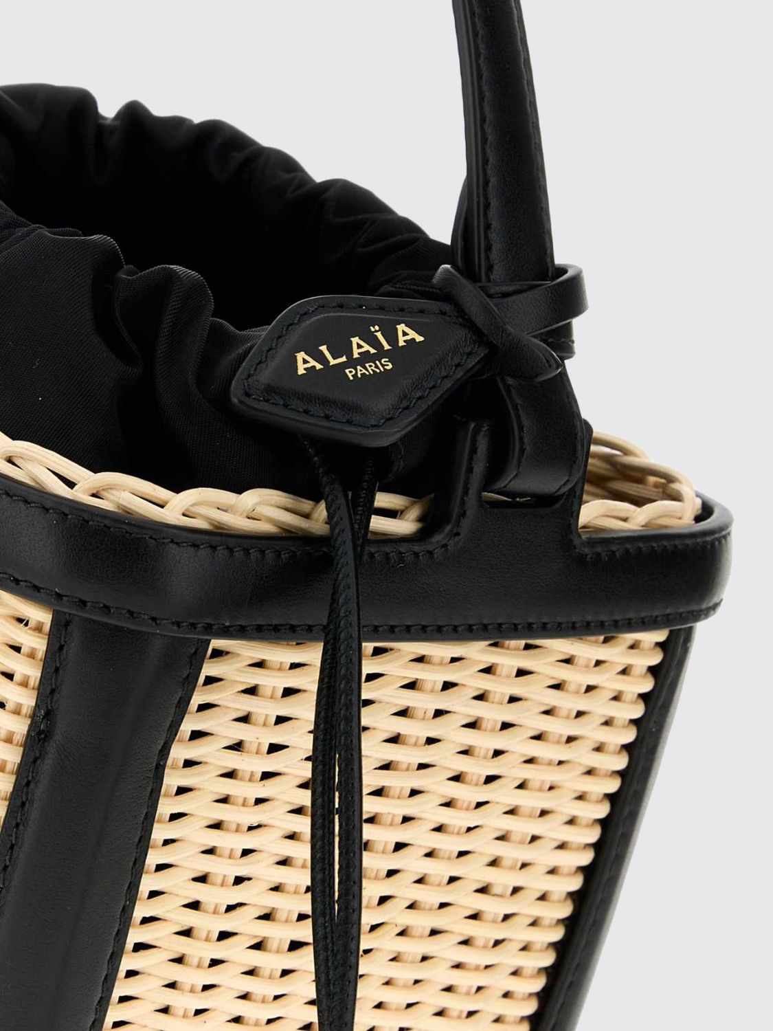wicker and leather mini bucket bag with drawstring closure