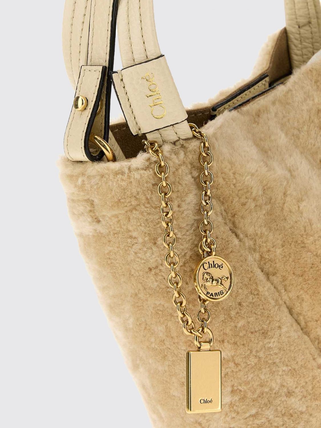chloé spin shearling shoulder bag with double handle and decorative charm