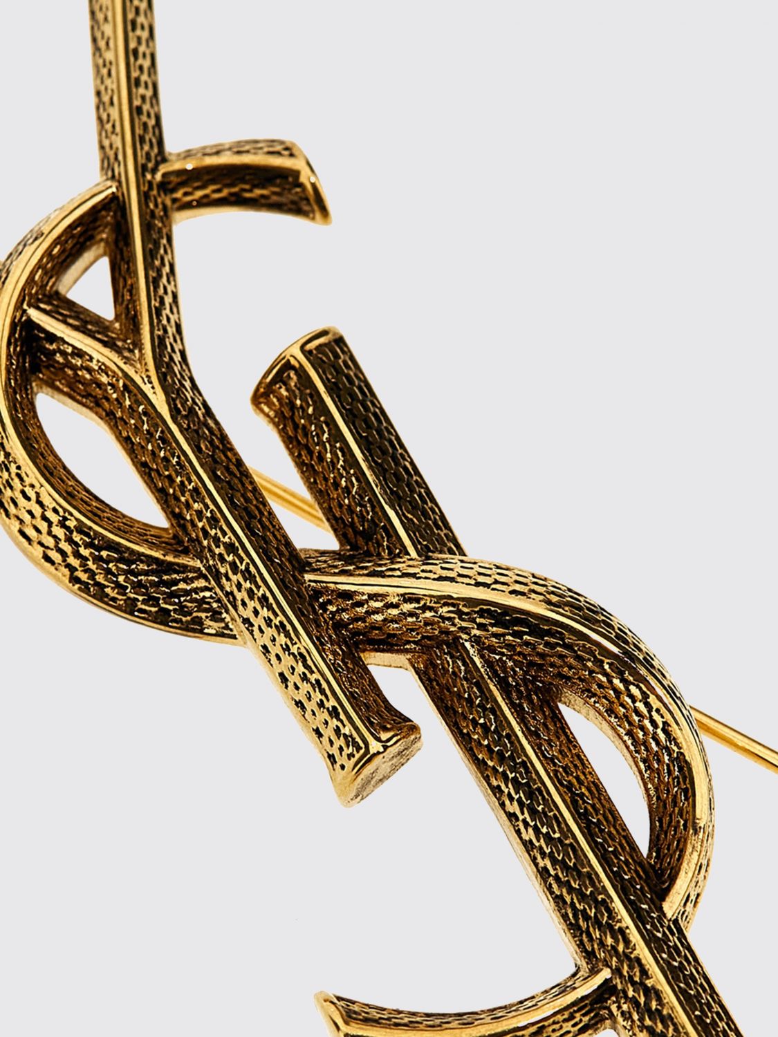 cassandre ysl monogram brooch in golden brass
