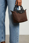 the longchamp xs le pliage energy handbag features a compact silhouette