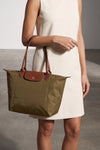 the longchamp le pliage original l shoulder bag is distinguished by a capaciou