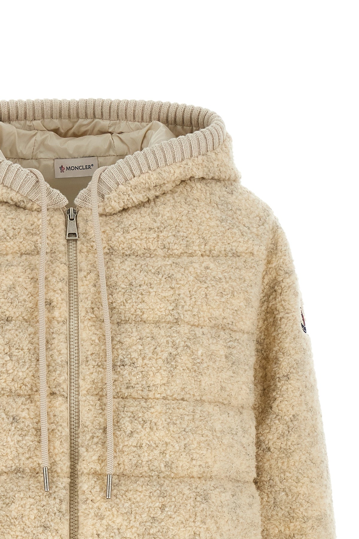 the moncler sweatshirt stands out for its hybrid construction that combines knit