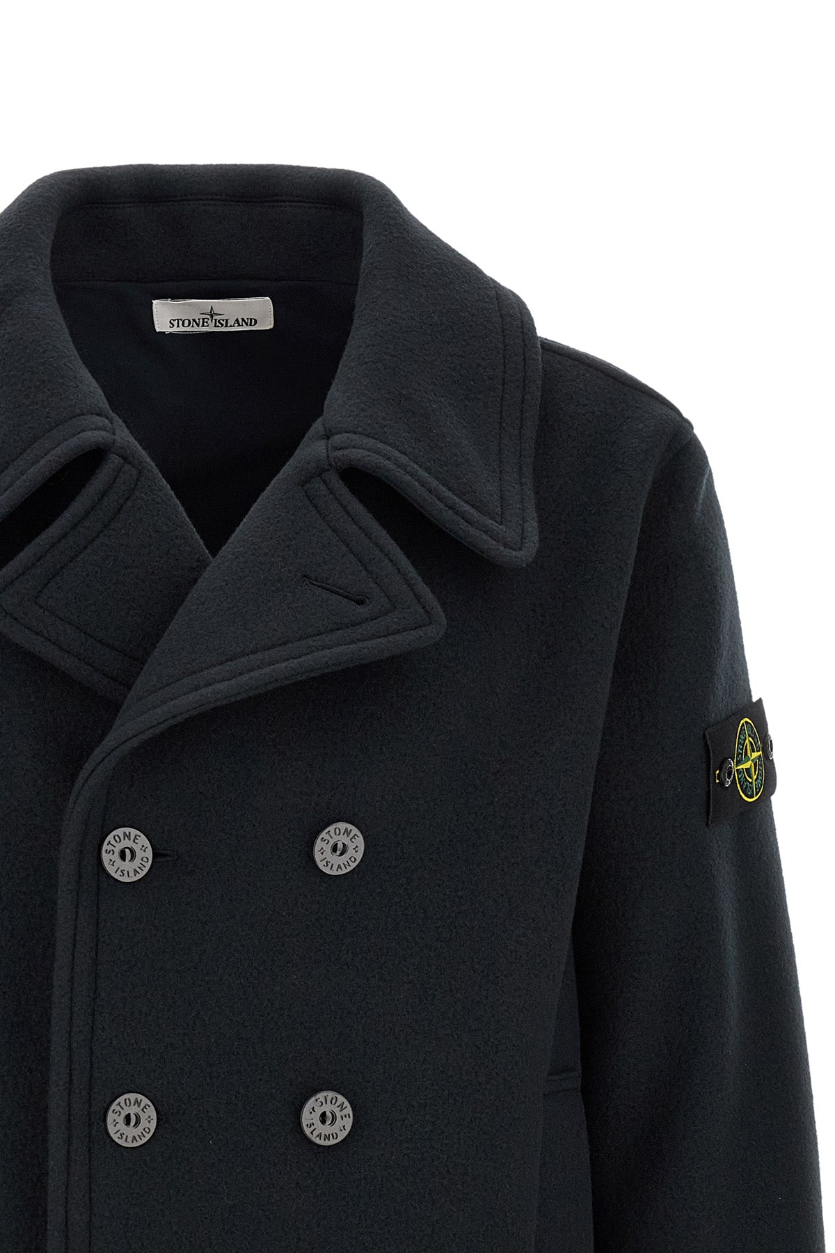 the stone island outerwear in a deep navy blue nuance imposes itself