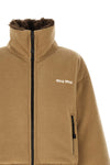 miu miu short down jacket redefines volumes through a compact and structured sil