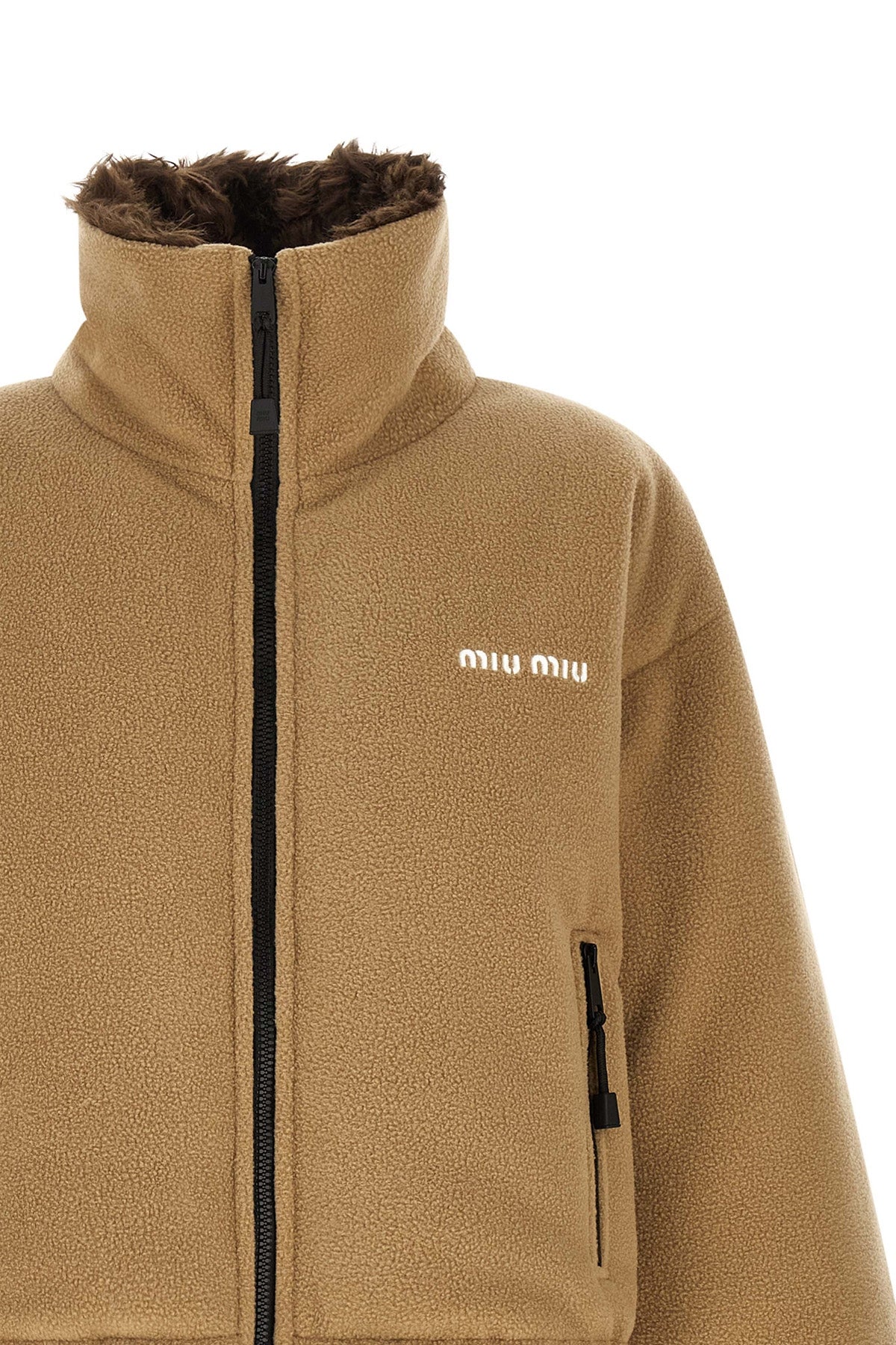 miu miu short down jacket redefines volumes through a compact and structured sil