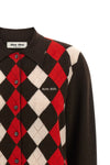 the miu miu cardigan redefines the codes of classic knitwear through a structure