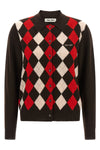the miu miu cardigan redefines the codes of classic knitwear through a structure