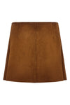 suede mini skirt undergoing final waxing treatment