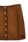 suede mini skirt undergoing final waxing treatment