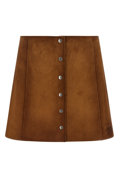 suede mini skirt undergoing final waxing treatment