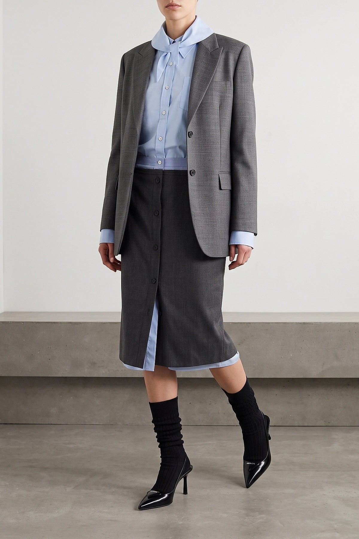 the prada midi skirt in a fine virgin wool and mohair blend is distinguished by