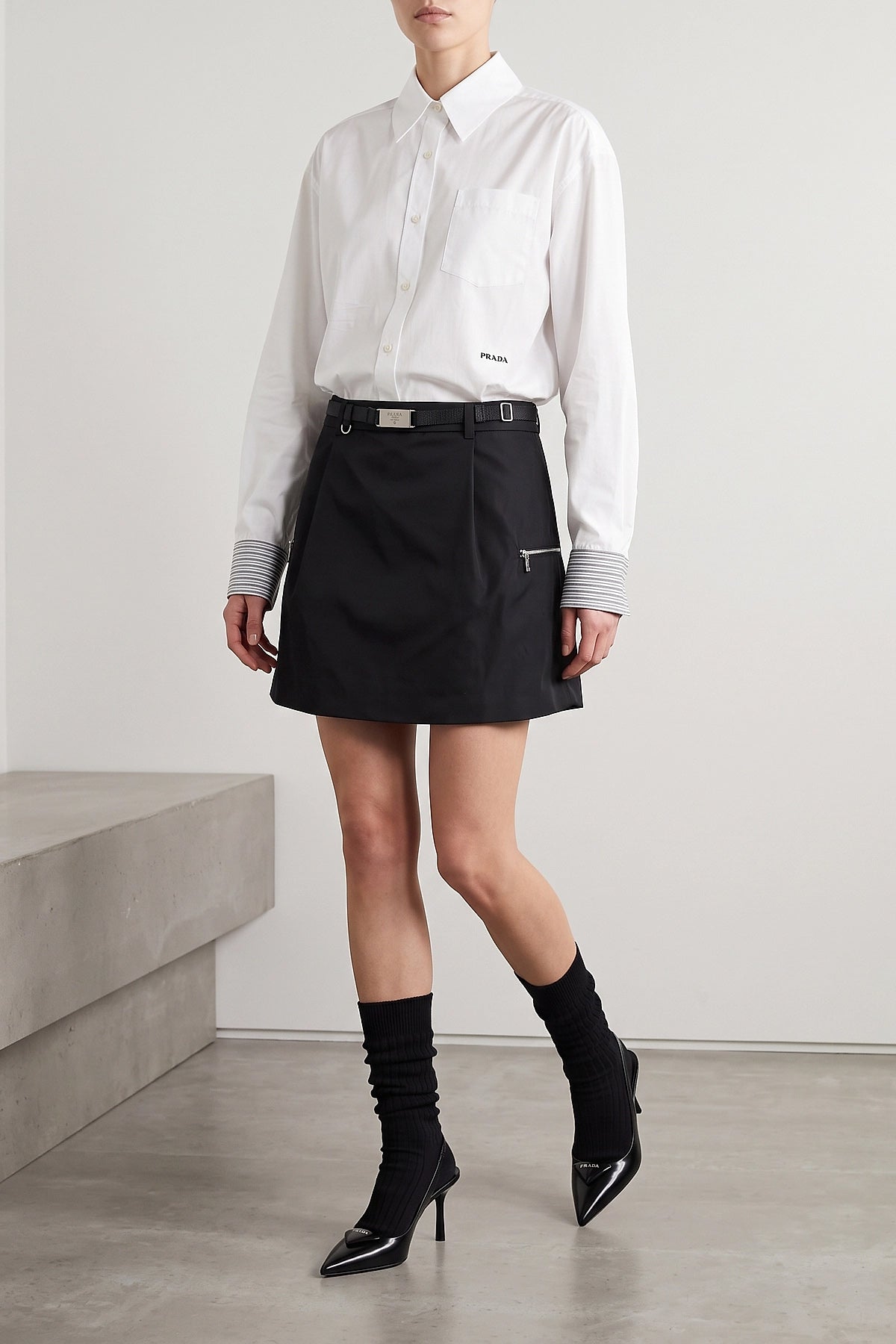 the prada poplin shirt redefines classic tailoring through unexpected details an