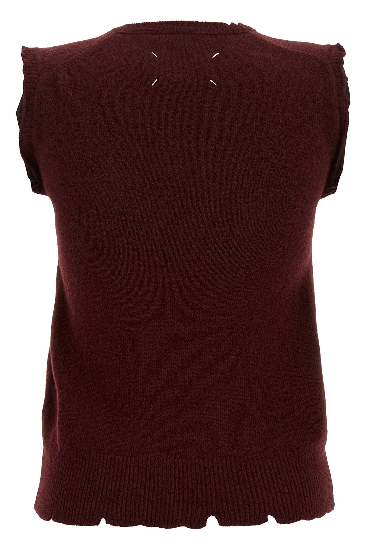 the maison margiela vest redefines the codes of knitwear through a lived and dec
