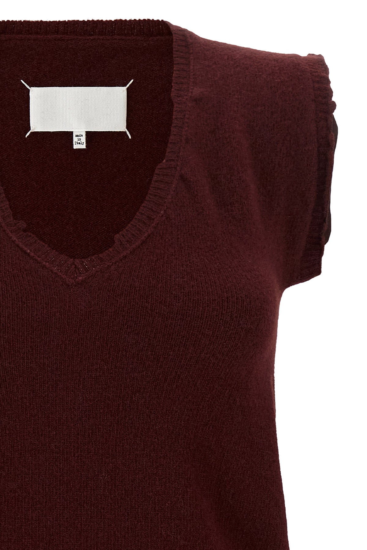the maison margiela vest redefines the codes of knitwear through a lived and dec