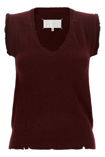 the maison margiela vest redefines the codes of knitwear through a lived and dec