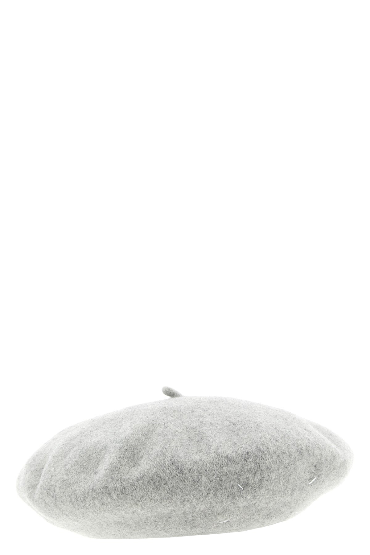 the maison margiela cap reinterprets a wardrobe classic through the maisons dec