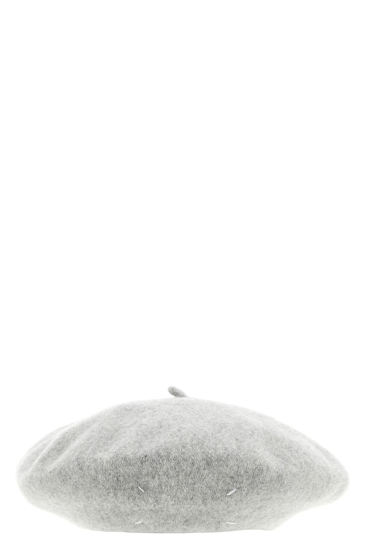 the maison margiela cap reinterprets a wardrobe classic through the maisons dec