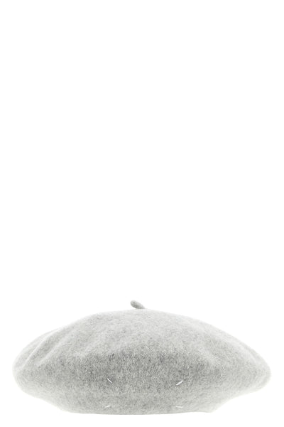 the maison margiela cap reinterprets a wardrobe classic through the maisons dec