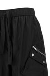 ganni multi-pocket trousers define a new urban silhouette through wide volumes a