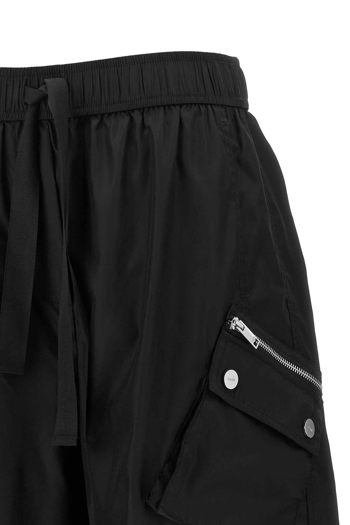 ganni multi-pocket trousers define a new urban silhouette through wide volumes a
