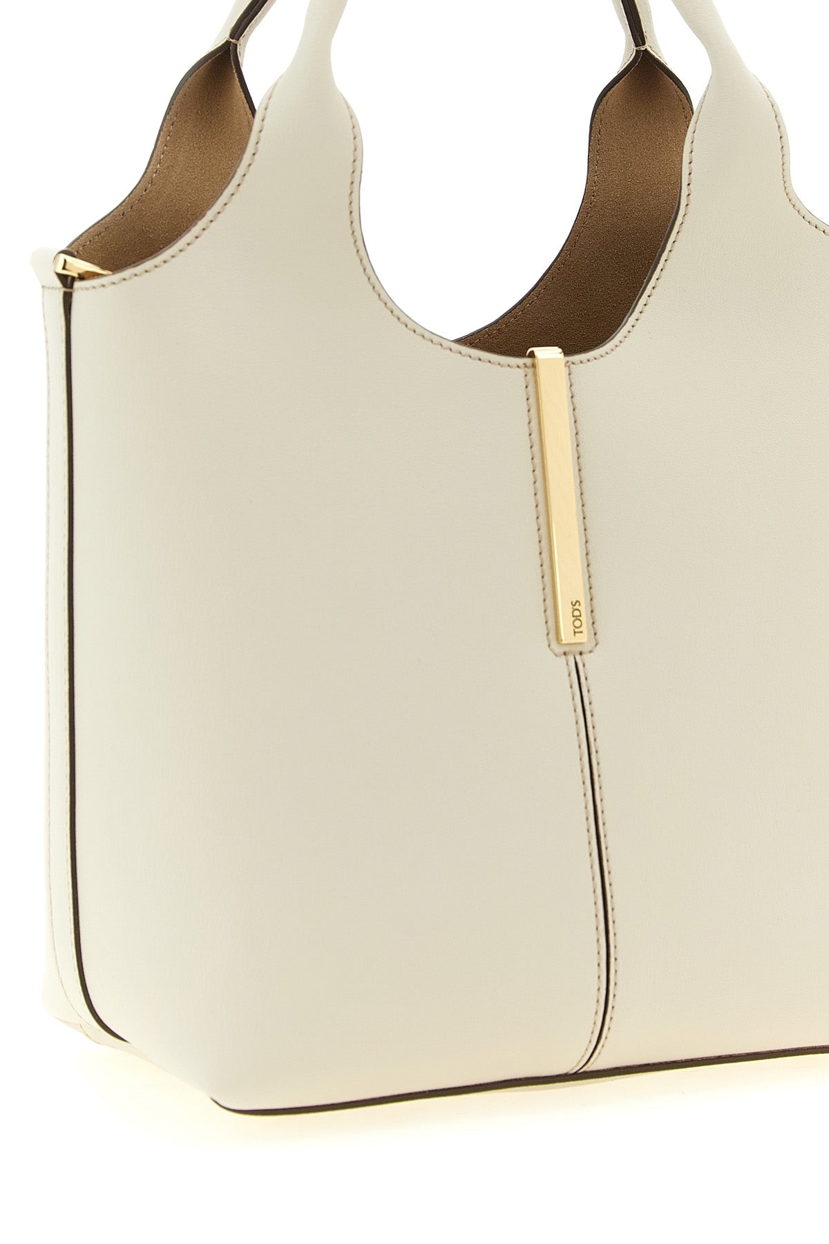 the tods mini tote bag is made of soft cream calf leather